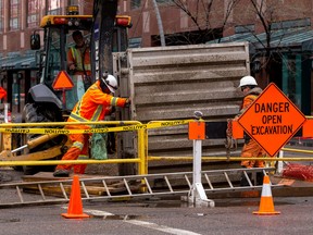 Construction workers are seen in Downtown Edmonton  May 6, 2022.