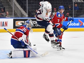 Regina Pats at Edmonton Oil Kings on Sept. 29, 2022. The Pats' Easton Armstrong leaps in front of Oil Kings goaltender Kolby Hay. Also shown is the Oil Kings' Ethan Peters (7).