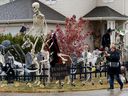 A visitor stops to take pictures of the Halloween decorations at home, 9004 158 Ave., in Edmonton, on Oct. 30, 2020. 