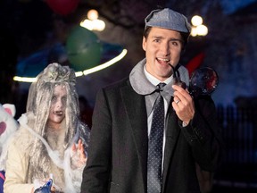 Prime Minister Justin Trudeau walks with his son Hadrien as they go trick or treating at Rideau Hall on Halloween in Ottawa on Wednesday, Oct. 31, 2018.