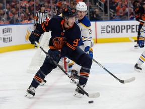The Edmonton Oilers' Ryan Nugent-Hopkins (93) battles the Buffalo Sabres' Owen Power (25) during third period NHL action at Rogers Place in Edmonton, Tuesday Oct. 18, 2022. The Sabres won 4 to 2. Photo By David Bloom