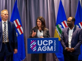 Danielle Smith speaks at UCP annual general meeting beside Lethbridge East MLA Nathan Neudorf, Deputy Premier, Infrastructure Minister and Deputy Premier and Minister of Skilled Trades and Professions, Kaycee Madu on Oct. 22 at the River Cree Resort and Casino.