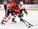 Jujhar Khaira #16 of the Chicago Blackhawks and Marcus Pettersson #28 of the Pittsburgh Penguins battle for control of the puck during the second period on Nov. 20, 2022 at the United Center in Chicago, Illinois.
