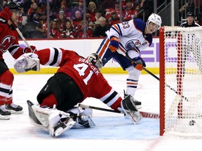 Ryan Nugent-Hopkins #93 of the Edmonton Oilers shoots past goaltender Vitek Vanecek #41 of the New Jersey Devils to score during the third period of the game at Prudential Center on Nov. 21, 2022 in Newark, New Jersey.