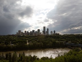 The sun breaks through clouds forming over downtown Edmonton in Edmonton, on Tuesday, July 19, 2022.
