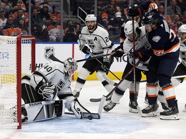 The Los Angeles Kings' goalie Calvin Petersen (40) makes a save as the Edmonton Oilers' Mattias Janmark (26) battles Sean Durzi (50) during first period NHL action at Rogers Place in Edmonton, Wednesday Nov. 16, 2022.