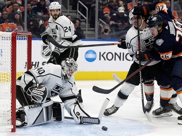 The Los Angeles Kings' goalie Calvin Petersen (40) makes a save as the Edmonton Oilers' Mattias Janmark (26) battles Sean Durzi (50) during first period NHL action at Rogers Place in Edmonton, Wednesday Nov. 16, 2022.