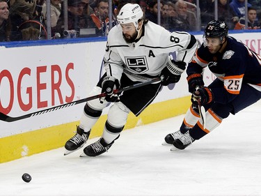 The Edmonton Oilers' Darnell Nurse (25) battles the Los Angeles Kings' Drew Doughty (8) during first period NHL action at Rogers Place in Edmonton, Wednesday Nov. 16, 2022.