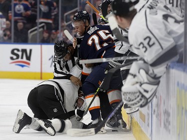The Edmonton Oilers' Darnell Nurse (25) tries to fight the Los Angeles Kings' Alexander Edler (2) during second period NHL action at Rogers Place in Edmonton, Wednesday Nov. 16, 2022.