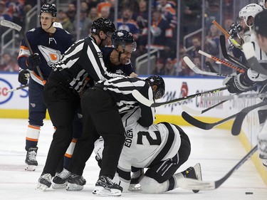 The Edmonton Oilers' Darnell Nurse (25) tries to fight the Los Angeles Kings' Alexander Edler (2) during second period NHL action at Rogers Place in Edmonton, Wednesday Nov. 16, 2022.