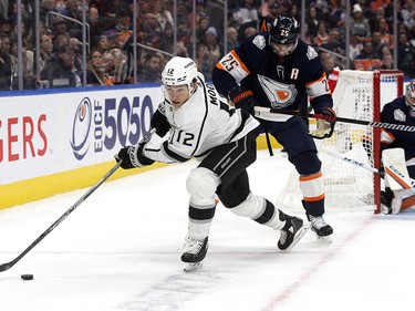 The Edmonton Oilers' Darnell Nurse (25) battles the Los Angeles Kings' Trevor Moore (12) during second period NHL action at Rogers Place in Edmonton, Wednesday Nov. 16, 2022.
