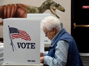 A voter casts their ballot in the U.S. midterm election, at Dinosaur Journey Musuem in Fruita, Colorado, Tuesday, Nov. 8, 2022.