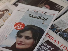 A newspaper with a cover picture of Mahsa Amini, a woman who died after being arrested by Iranian morality police, is seen in Tehran, Sept. 18, 2022.