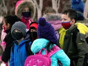 School children outside a school in southwest Edmonton on Feb. 14, 2022, the first day that the mask mandate in the province of Alberta was lifted. School children were no longer required to wear face masks at any school in the province.