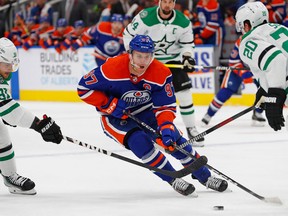 Dallas Stars forward Tyler Sequin (91) tries to knock the puck away from Edmonton Oilers forward Connor McDavid (97) during the first period at Rogers Place on Saturday, Nov. 5, 2022.