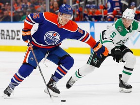 Edmonton Oilers forward Dylan Holloway (55) is chased on ice by Dallas Stars defenseman Nils Lundkvist (5) during the third period at Rogers Place on November 5, 2022.