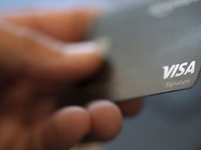 A Visa logo is shown on a credit card in New Orleans on August 11, 2019. Equifax says Canadians are leaning more heavily on credit cards amid persistent inflation and rising interest rates.