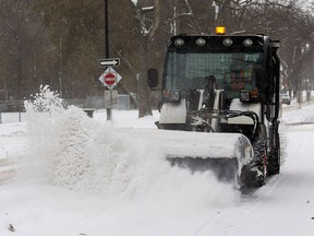 A street sweeper cleans snow from bike lanes in the Garneau area on Monday, Nov. 7, 2022 in Edmonton.