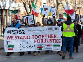 Holding placards reading "No to Islamic Republic" and "Women, Life, Freedom," more than 100 protesters rallied against Iran's government on Saturday, Nov. 19, 2022 along Whyte Avenue.