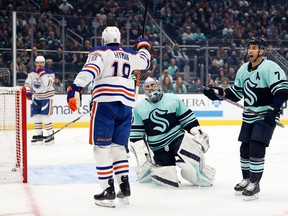 Philipp Grubauer #31 and Jordan Eberle #7 of the Seattle Kraken react after a goal by Zach Hyman #18 of the Edmonton Oilers during the first period at Climate Pledge Arena on December 30, 2022 in Seattle, Washington.