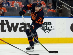 Edmonton Oilers' Leon Draisaitl (29) shoots past New York Islanders' Andy Greene (4) during first period NHL action at Rogers Place in Edmonton, on Friday, Feb. 11, 2022. Photo by Ian Kucerak