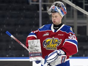 Edmonton Oil Kings goaltender Kolby Hay adjusts his equipment in a game against the Medicine Hat Tigers at Rogers Place in Edmonton on Dec. 6, 2022.