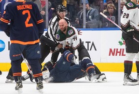 Zack Kassian of the Coyotes and Klim Kostin of the Edmonton Oilers face off during the NHL third period in Edmonton on Wednesday, Dec. 7, 2022.