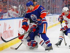 Edmonton Oilers defencemen Evan Bouchard (2) checks Montreal Canadiens forward Nick Suzuki on Dec. 3.