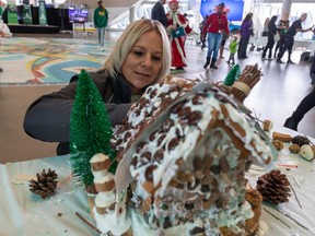 Sherri Mulcahy with the Taste of Edmonton team builds their gingerbread house as the Christmas Bureau of Edmonton's 2022 holiday campaign kicks off with its annual Gingerbread House Competition on Thursday, Nov. 17, 2022  in Edmonton. In 2021 the Christmas Bureau of Edmonton served over 35,000 clients, delivered over 1,200 hampers, distributed over 9,000 gift cards including 4,786 to teens, and logged over 6,350 volunteer hours. Greg Southam-Postmedia