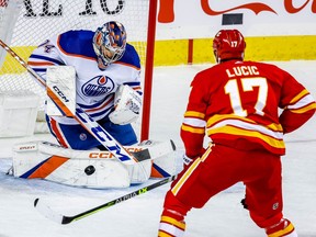 Edmonton Oilers goalie Stuart Skinner with a save on Milan Lucic of the Calgary Flames during NHL hockey at the Scotiabank Saddledome in Calgary on Tuesday, December 27, 2022. AL CHAREST/POSTMEDIA