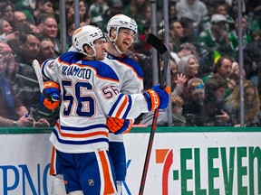 Edmonton Oilers right wing Kailer Yamamoto (56) and left wing Warren Foegele (37) celebrate after Foegele scores a goal against the Dallas Stars during the third period at the American Airlines Center.