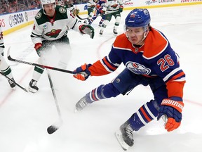 Mattias Janmark (26) of the Edmonton Oilers battles the Minnesota Wild during first period NHL action in Edmonton on Dec. 9, 2022.