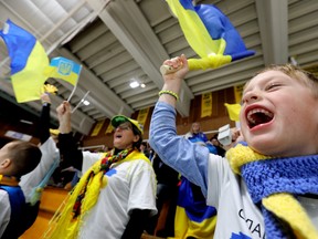 A young hockey fan cheers as the Ukrainian U25 national team takes on the University of Alberta Golden Bears for a charity hockey game at Clare Drake Arena, in Edmonton on Tuesday Jan. 03, 2023. The game raised funds for people affected by the Russian invasion of Ukraine.