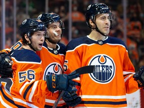 Kailer Yamamoto #56, Derek Ryan #10 and Evan Bouchard #75 of the Edmonton Oilers celebrate a goal against the Ottawa Senators during the second period at Rogers Place on Jan. 15, 2022.