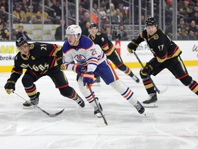 LAS VEGAS, NEVADA – JANUARY 14: Mattias Janmark #26 of the Edmonton Oilers skates with the puck against Alec Martinez #23 and Ben Hutton #17 of the Vegas Golden Knights before scoring a goal in the first period of their game at T-Mobile Arena on January 14, 2023 in Las Vegas, Nevada.