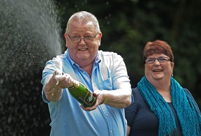 Colin Weir (L) and his wife Chris pose for pictures during a photocall in Falkirk, Scotland, on July 15, 2011.