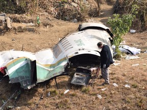 A member of a French team investigates the wreckage of a Yeti Airlines aircraft, in Pokhara, Nepal January 18, 2023.