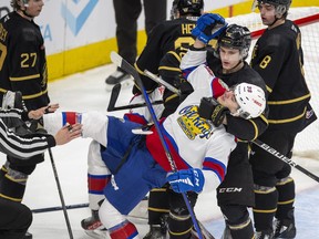 Edmonton Oil Kings forward Rilen Kovacevic is pulled down by the Brandon Wheat Kings' Caleb Hadland at Rogers Place on Sunday, Jan. 22, 2023.