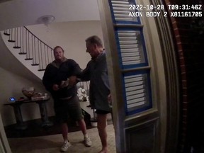A screenshot from a police body camera video shows David DePape holding onto Paul Pelosi, the husband of then-House Speaker Nancy Pelosi, in the couple's house on Oct. 28, 2022, in San Francisco, Calif.