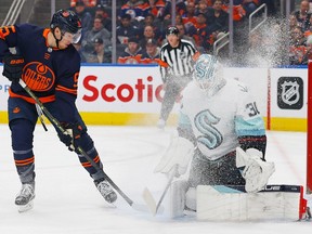 Seattle Kraken goaltender Martin Jones (30) makes a save on a deflection by Edmonton Oilers forward Dylan Holloway (55) during the first period at Rogers Place on Jan. 17, 2023.