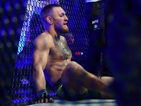 Conor McGregor reacts following an injury suffered against Dustin Poirier during UFC 264 at T-Mobile Arena.