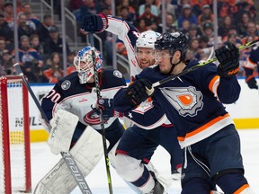Dylan Holloway (55) of the Edmonton Oilers, tries to get past Vladislav Gavrikov (4) of the Columbus Blue Jackets in the first period at Rogers Place in Edmonton on January 25, 2023.