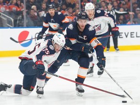 Connor McDavid (97) of the Edmonton Oilers, skates away from Tim Berni (75) of the Columbus Blue Jackets at Rogers Place in Edmonton on January 25, 2023.  Photo by Shaughn Butts-Postmedia