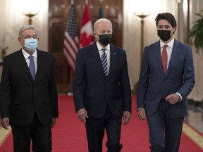 Canadian Prime Minister Justin Trudeau walks with United States President Joe Biden and Mexican President Andres Manuel Lopez Obrador to a meeting at the North American Leaders' Summit, on Thursday, Nov. 18, 2021 in Washington, D.C.