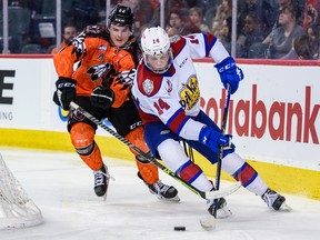 Calgary Hitmen defenceman Tyson Galloway chases the puck against Edmonton Oil Kings forward Marshall Finnie in this file photo from Scotiabank Saddledome taken on Feb. 4, 2023.