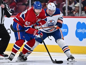 Joel Armia #40 of the Montreal Canadiens and Zach Hyman #18 of the Edmonton Oilers battle for the puck during the second period at the Bell Centre on Sunday, Feb. 12, 2023 in Montreal.