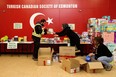 Members of the Turkish Canadian Society of Edmonton gather supplies at the organization's cultural centre (15450 105 Ave.) to send to Turkey following earthquakes on Monday.