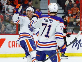 Edmonton Oilers center Connor McDavid (97) celebrates teammate center Ryan McLeod's (71) goal against the Ottawa Senators during second period NHL action at the Canadian Tire Centre on Saturday, Feb. 11, 2023.