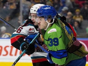 Edmonton Oil Kings forward Rilen Kovacevic (39) battles the  Kelowna Rockets' Marek Rocak (6) at Rogers Place in Edmonton on Friday, Feb. 24, 2023. The Oil Kings were wearing a special edition Teenage Mutant Ninja Turtles themed jersey to celebrate RE/MAX: Nickelodeon Night for the Children’s Miracle Network.