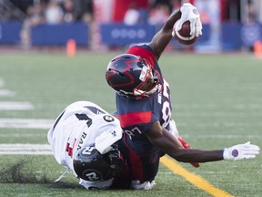 Montreal Alouettes receiver Eugene Lewis, right, is tackled by the Ottawa Redblacks' Chris Randle in Montreal on Aug. 2, 2019.